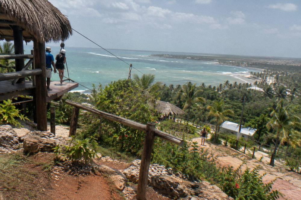 Zipline platform built into a hillside above dense green jungle canopy