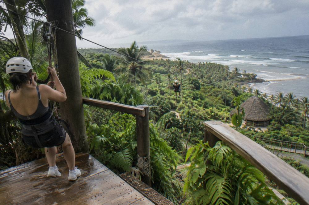 A zipline platform built into a lush green jungle hillside
