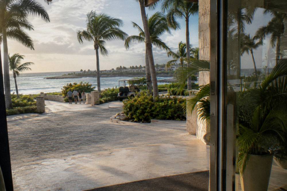 Resort hotel lobby entrance with palm trees in morning light