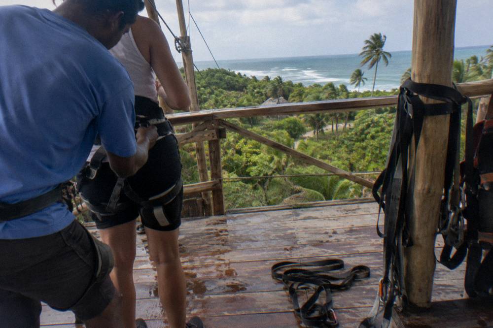A guide fitting a safety harness on a zipline platform