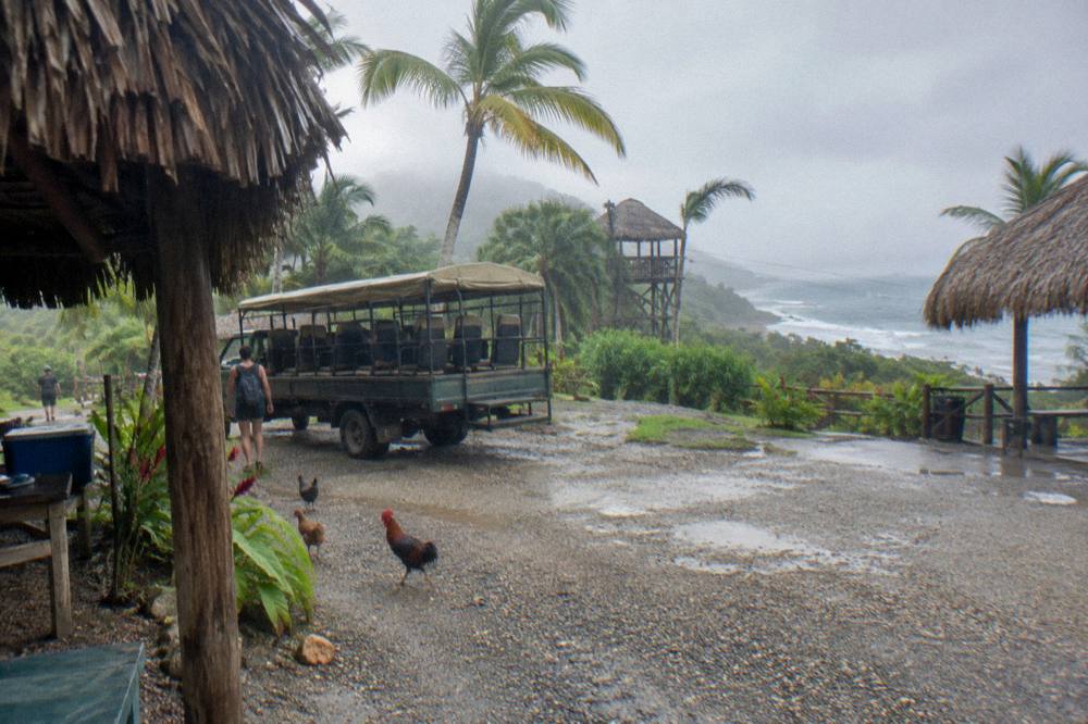 Open sided safari truck parked at a jungle ranch waiting for tour guests